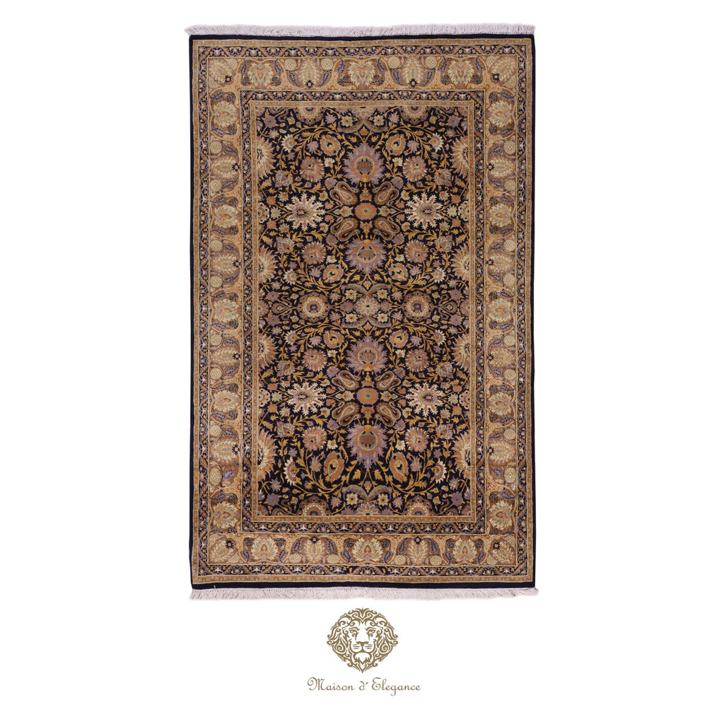 Decorative rug with intricate patterns on a navy background, featuring the brand 
