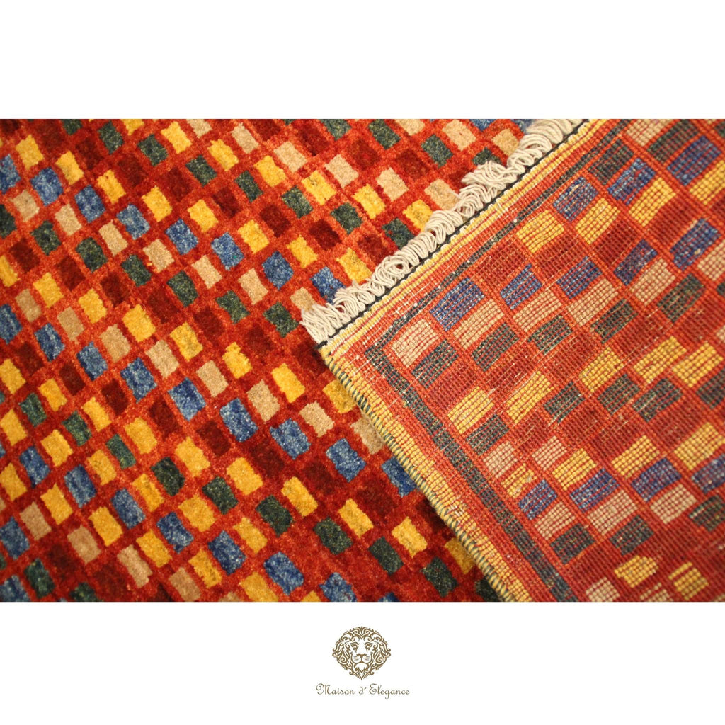 Close-up of a checkered patterned rug with a brand logo at the bottom.