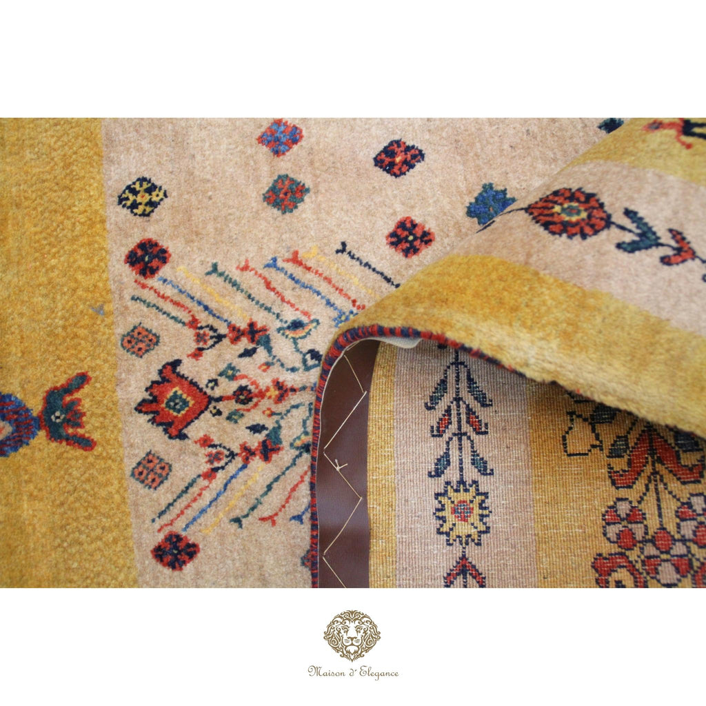 Close-up of a patterned rug with floral designs on a  gold background