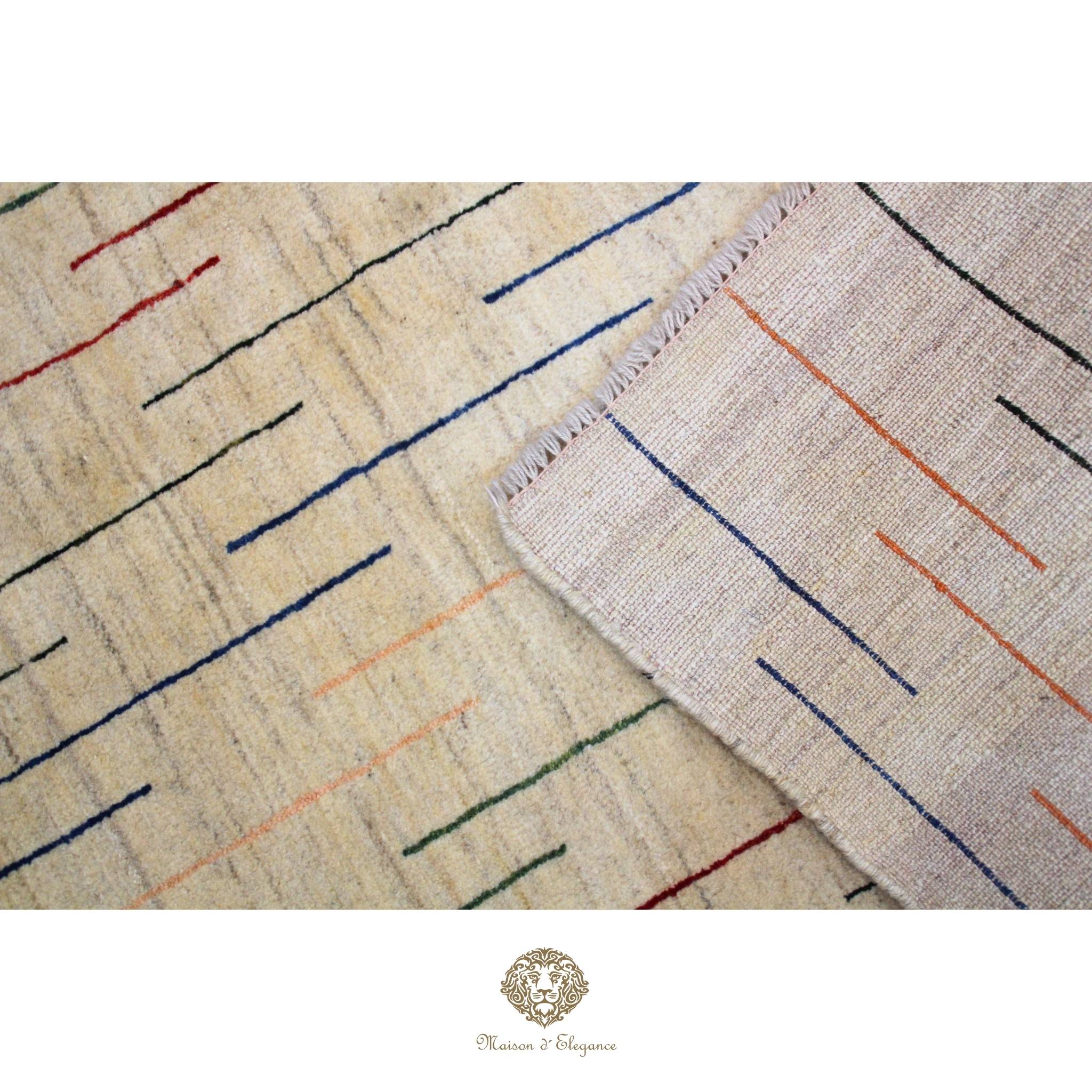 Close-up of a textured fabric with colorful lines on a beige background, featuring the brand 'Chandra Rugs'.