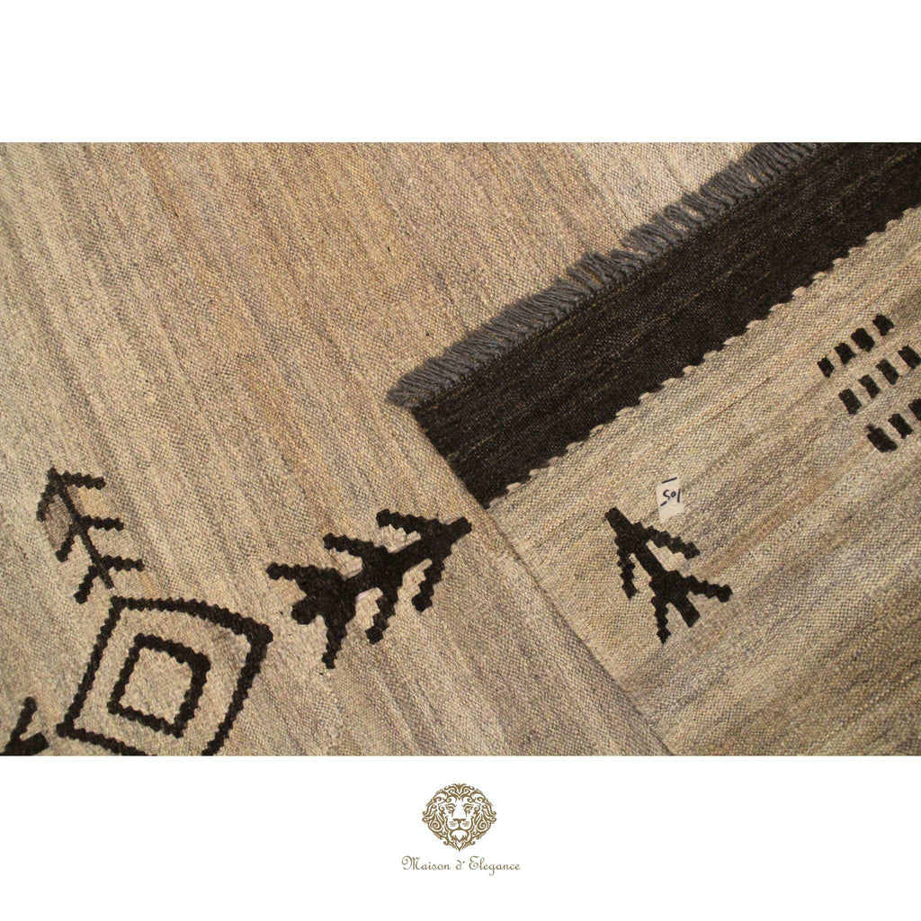Close-up of a textured rug with geometric patterns on a ivory background