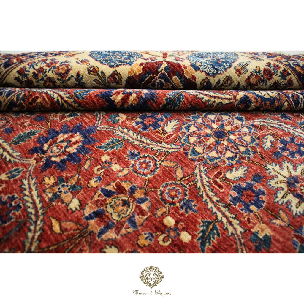 Close-up of a patterned rug with intricate designs on a red background.