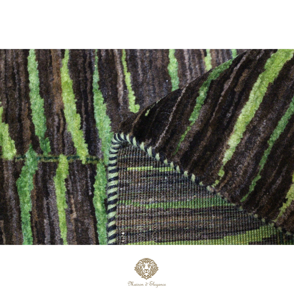 Close-up of a patterned fabric with green and brown stripes on a white background.