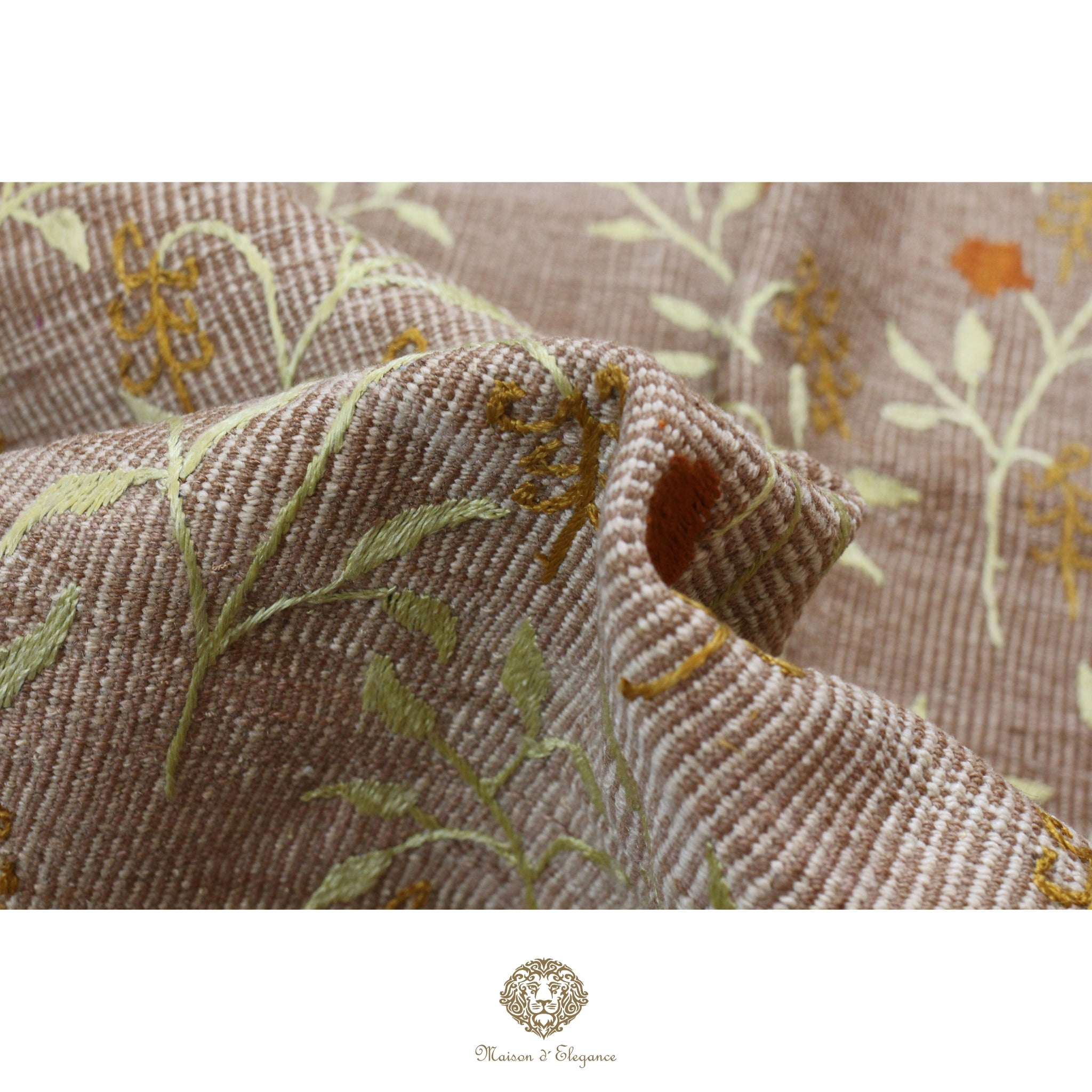 Close-up of textured fabric with floral embroidery on a neutral background