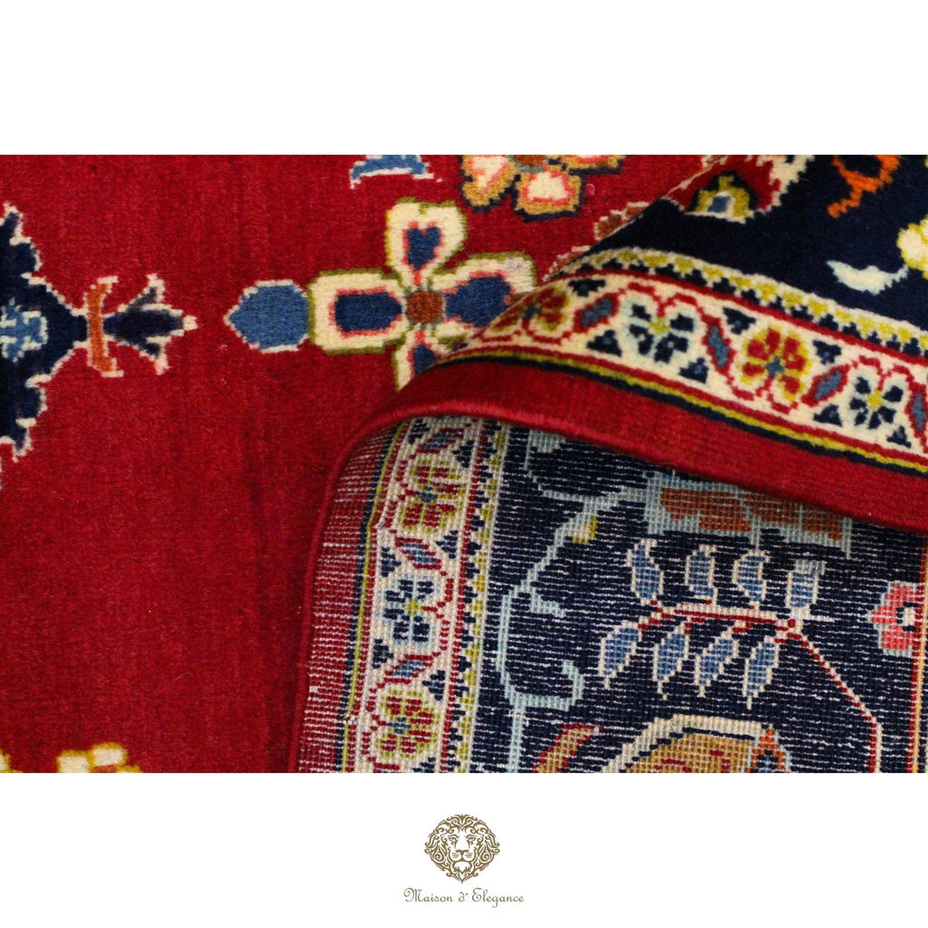 Close-up of a red and blue patterned fabric with intricate designs.