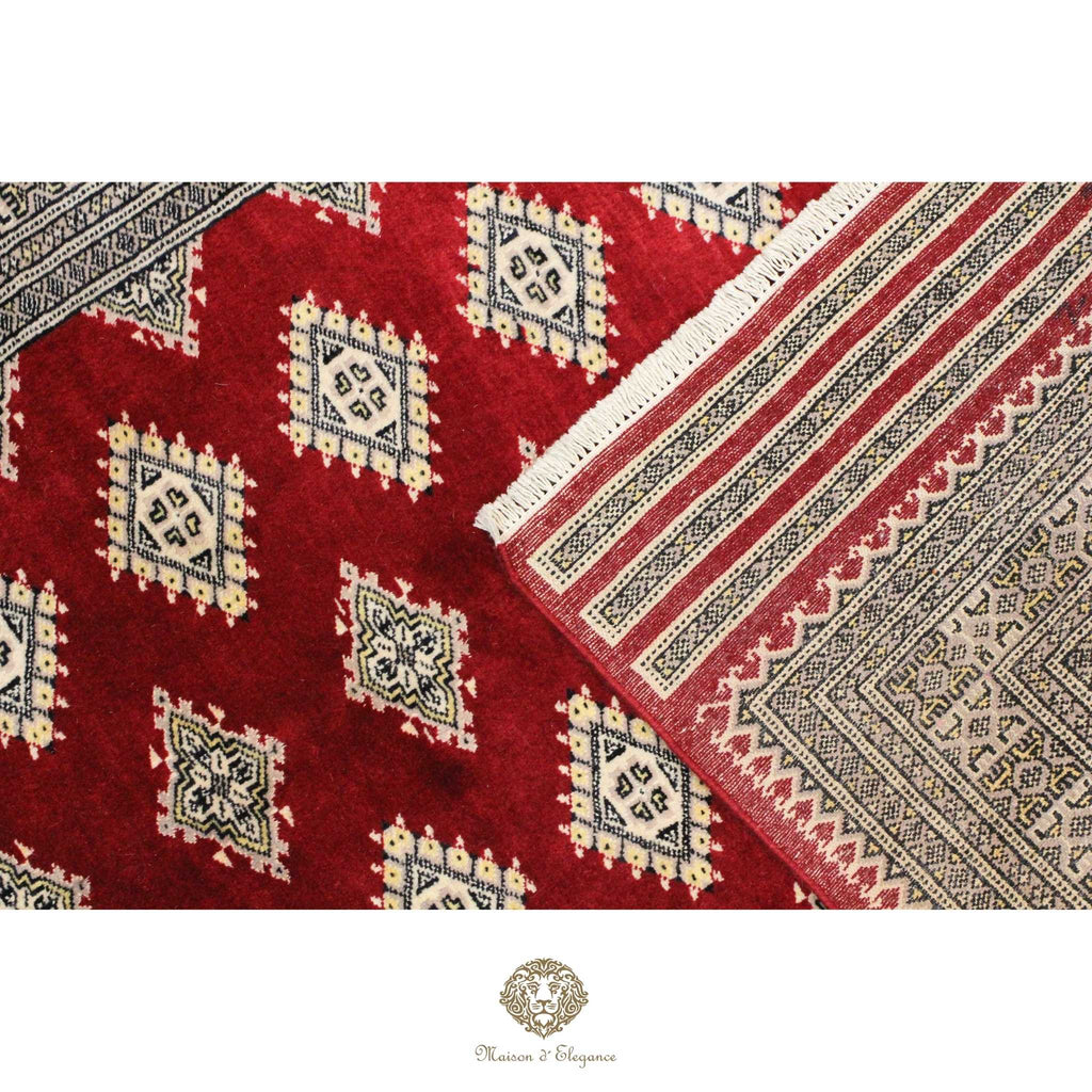 Close-up of a red patterned rug with geometric designs