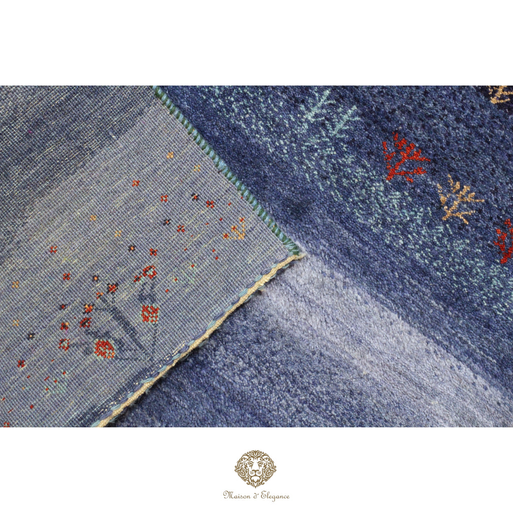 Close-up of a textured blue fabric with floral patterns on a white background.