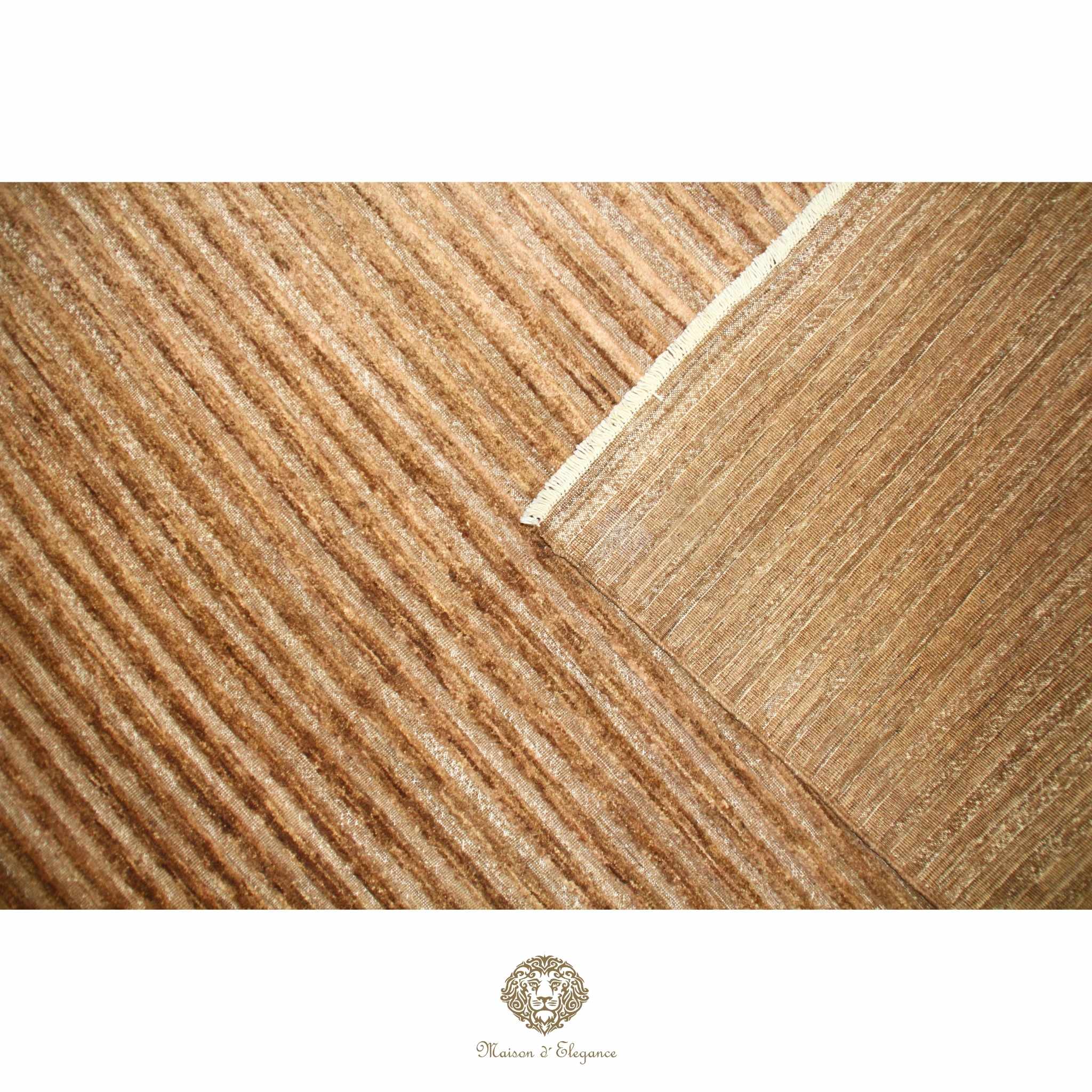 Close-up of wooden flooring with a visible brand logo at the bottom.