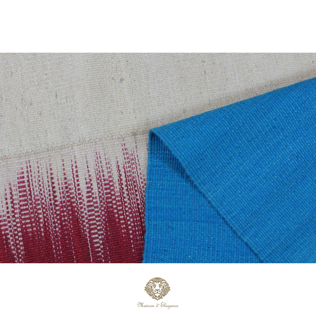 Close-up of a blue and red patterned fabric on a gray background