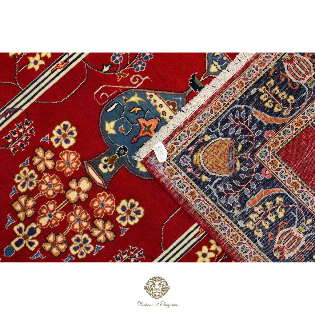 Close-up of a red and blue patterned rug with floral designs.