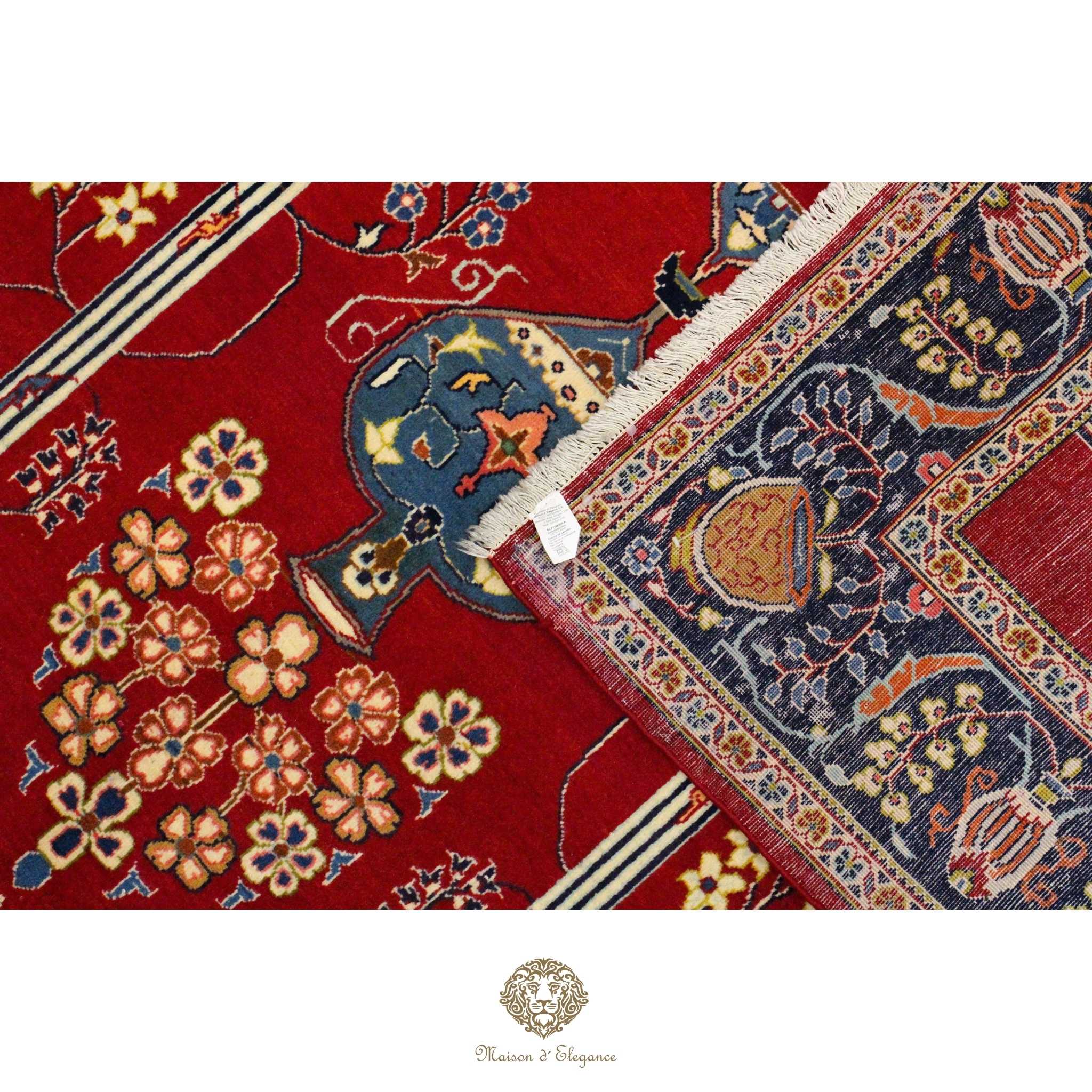 Close-up of a red and blue patterned rug with floral designs.