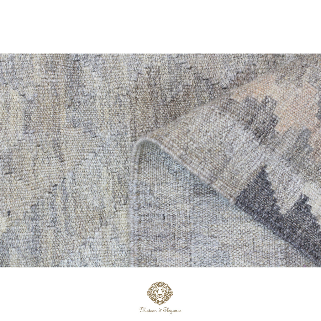 Close-up of a textured fabric with geometric pattern, brand logo visible.