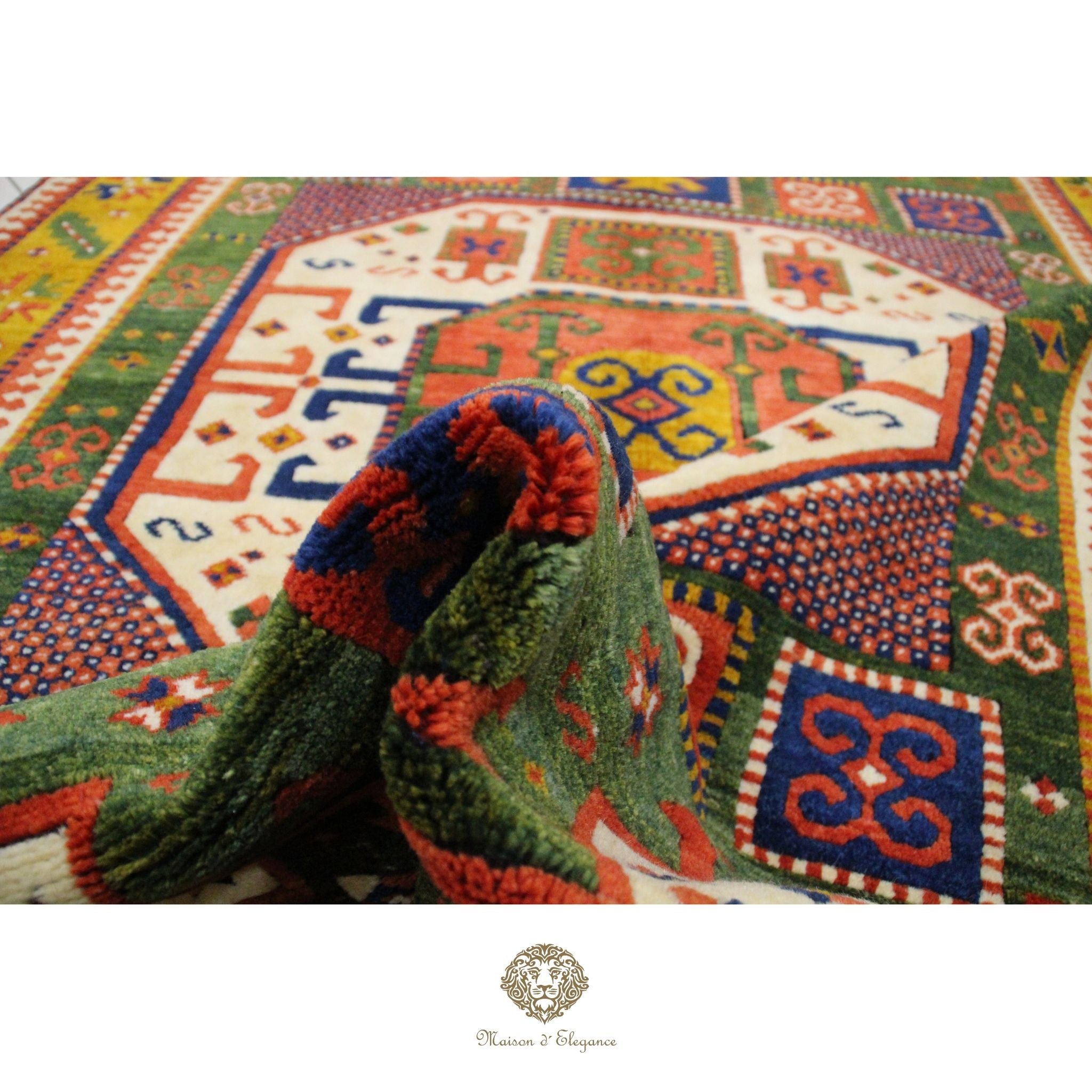 Colorful patterned rug with a green and red woven item on top, featuring a brand logo at the bottom.