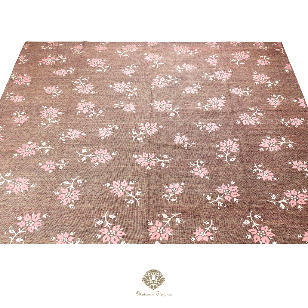 Floral patterned fabric with pink flowers on a brown background