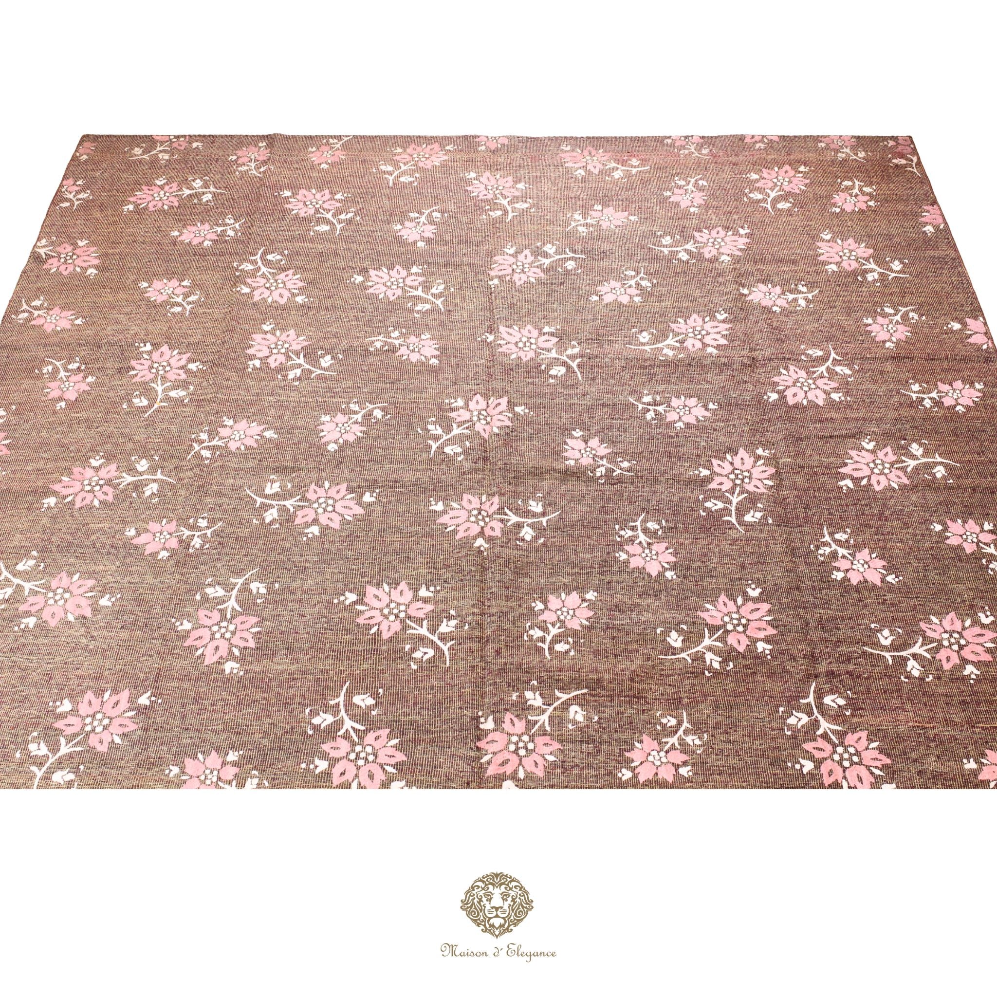 Floral patterned fabric with pink flowers on a brown background