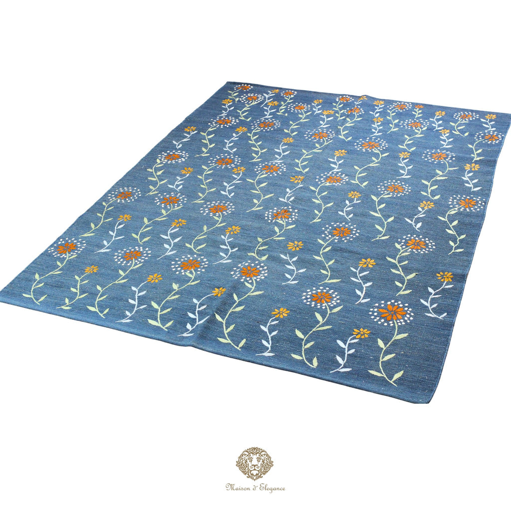 Blue floral patterned rug on a white background