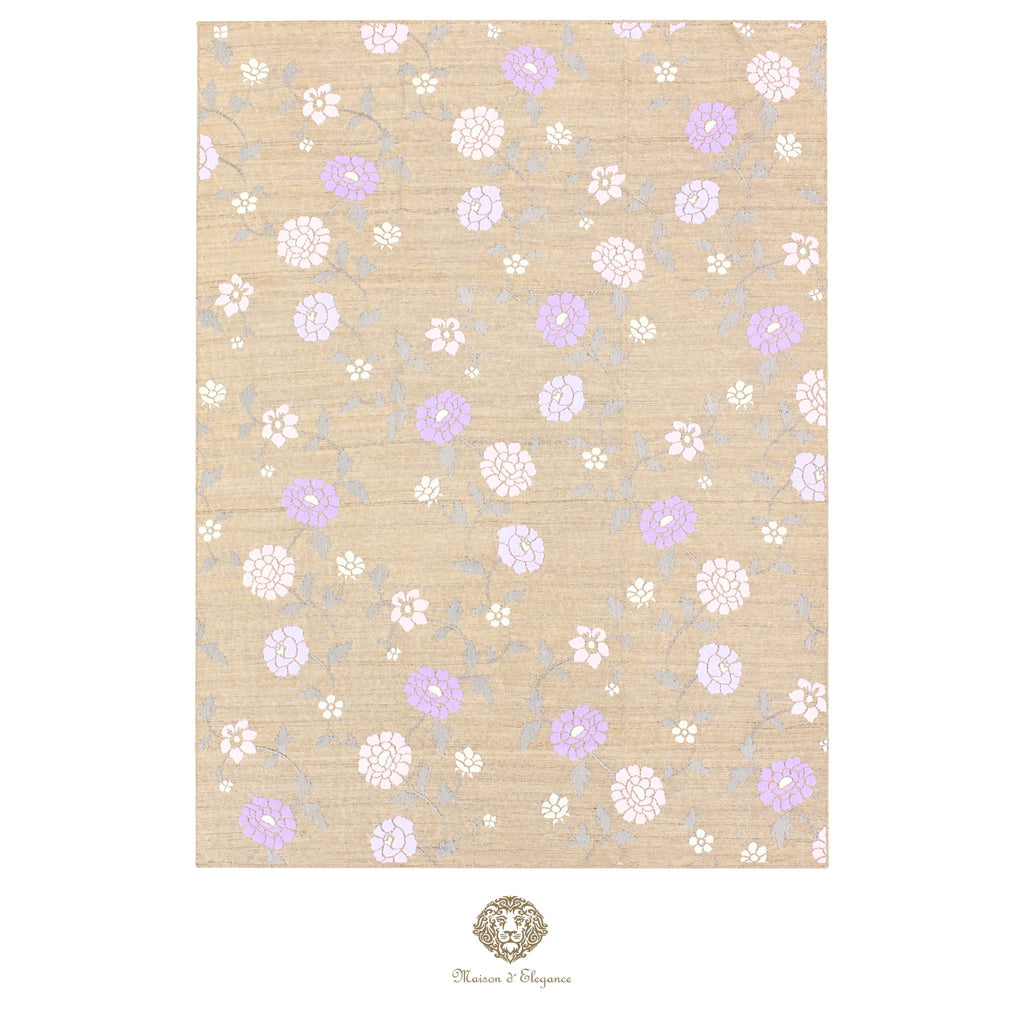 Floral patterned rug with purple and white flowers on a beige background, featuring a brand logo at the bottom.