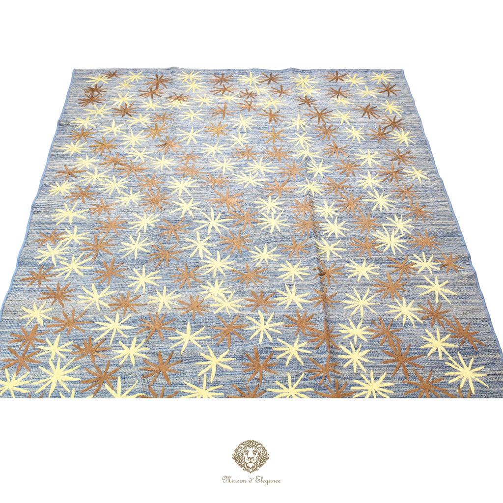 Patterned fabric with star-like shapes on a blue background