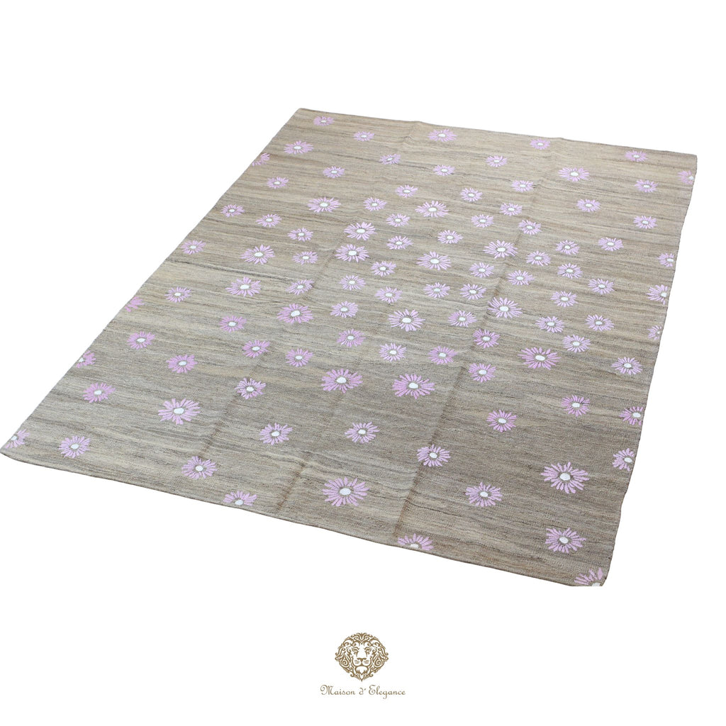 Beige fabric with purple floral pattern on a white background