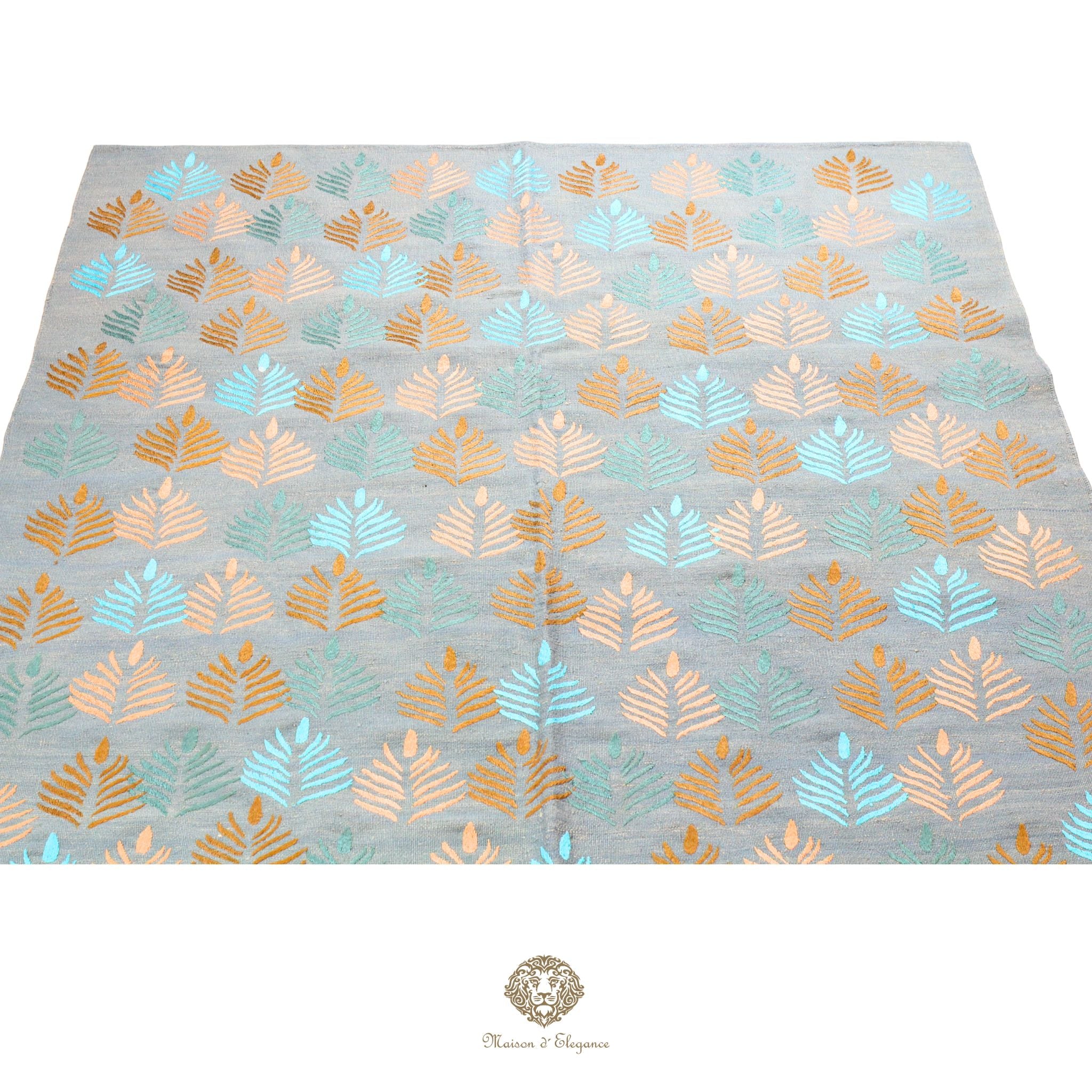 Patterned fabric with leaf design on a gray background, featuring gold and blue colors.