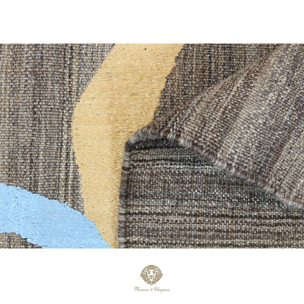 Close-up of textured fabric with geometric pattern, featuring shades of brown, beige, and blue.