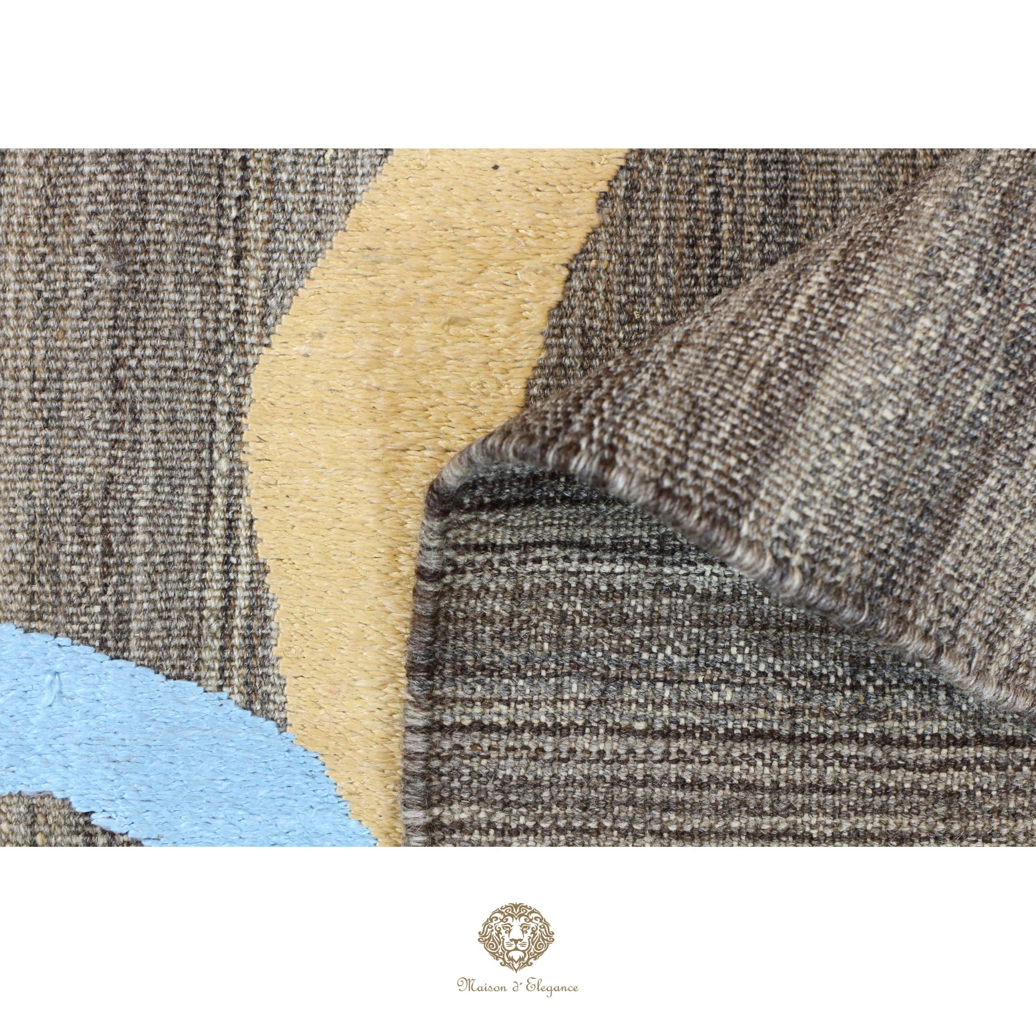 Close-up of textured fabric with geometric pattern, featuring shades of brown, beige, and blue.