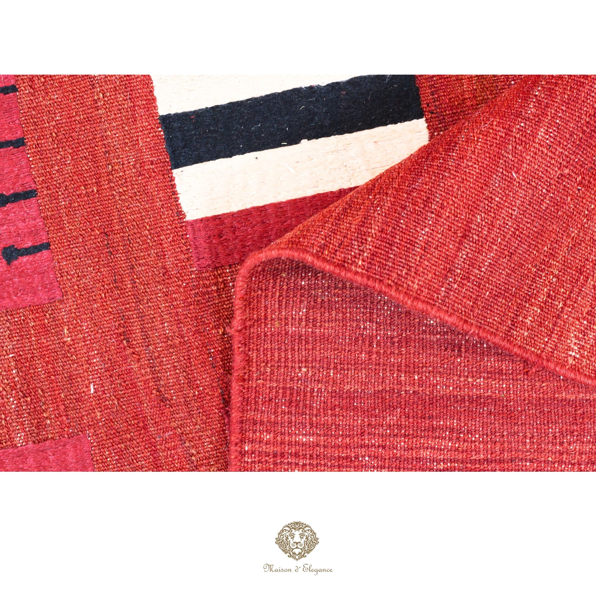 Close-up of a textured red fabric with a brand logo at the bottom.