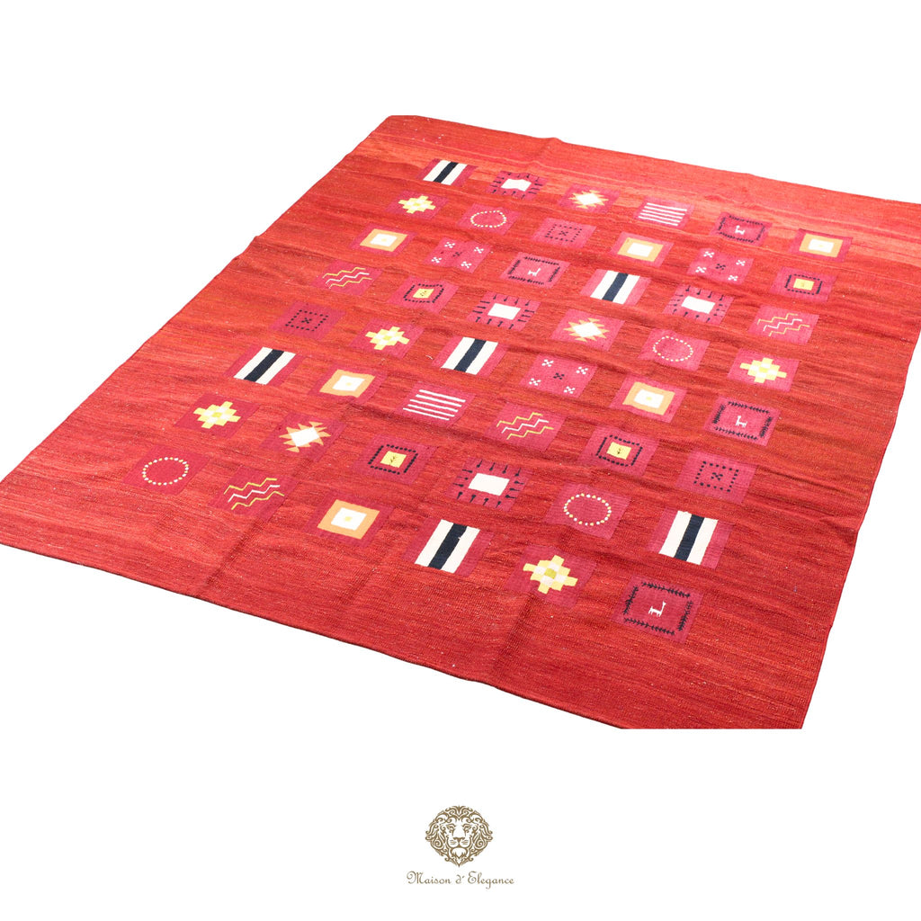 Red patterned rug with geometric designs on a red background