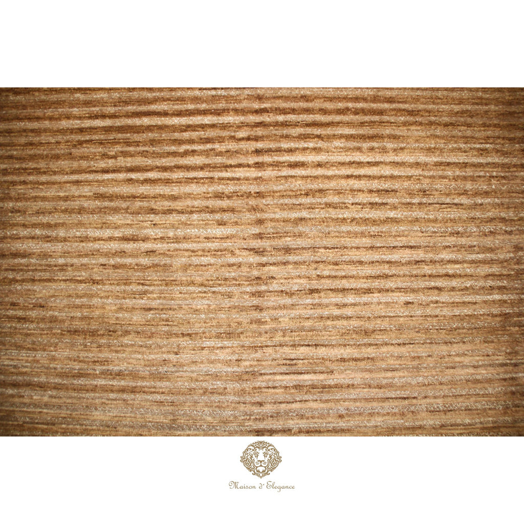 Textured brown rug with a brand logo at the bottom right corner