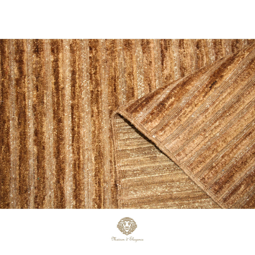 Close-up of a textured brown rug with a brand logo at the bottom.