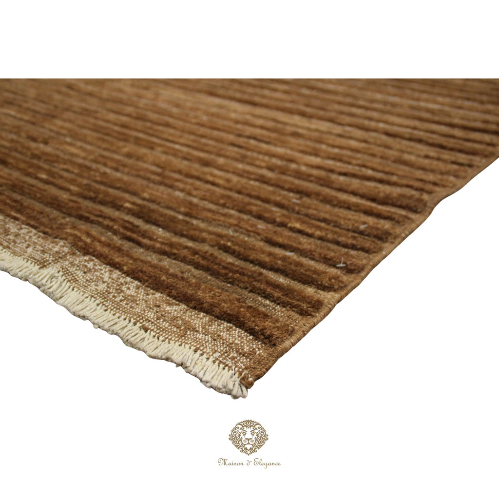 Brown textured rug with a visible brand logo in the corner.