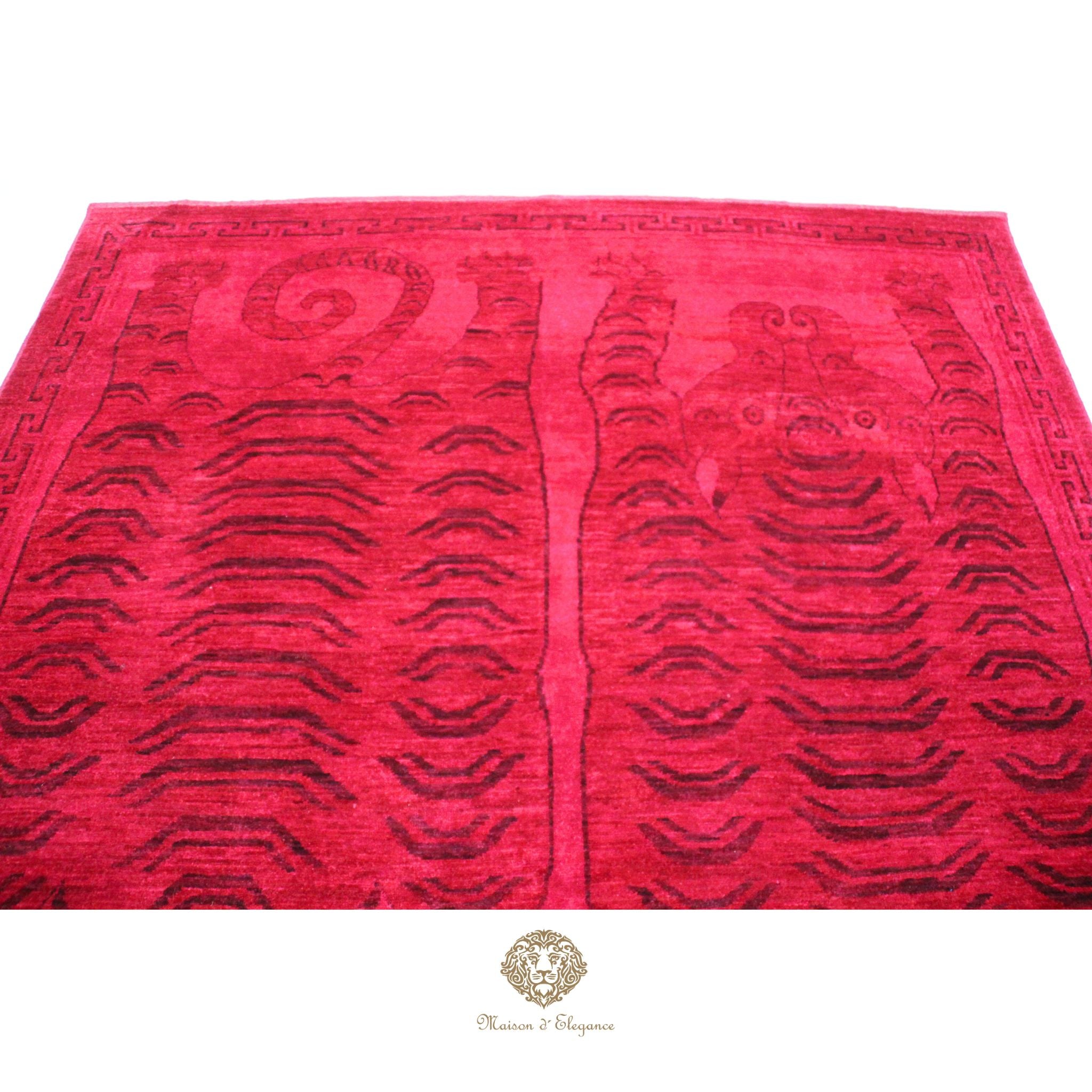 Red patterned rug with black designs on a red background