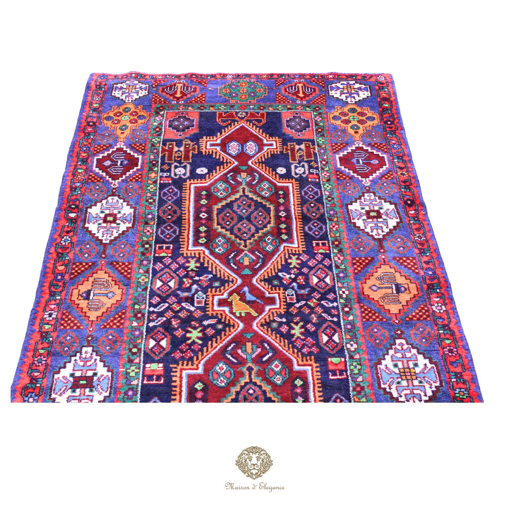 Colorful patterned rug with intricate designs on a navy background