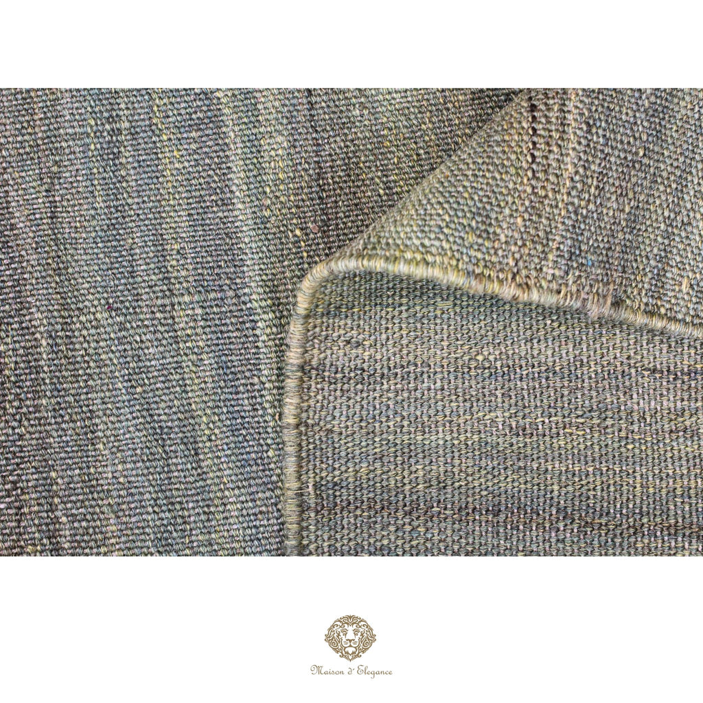 Close-up of denim fabric with a visible brand logo at the bottom.
