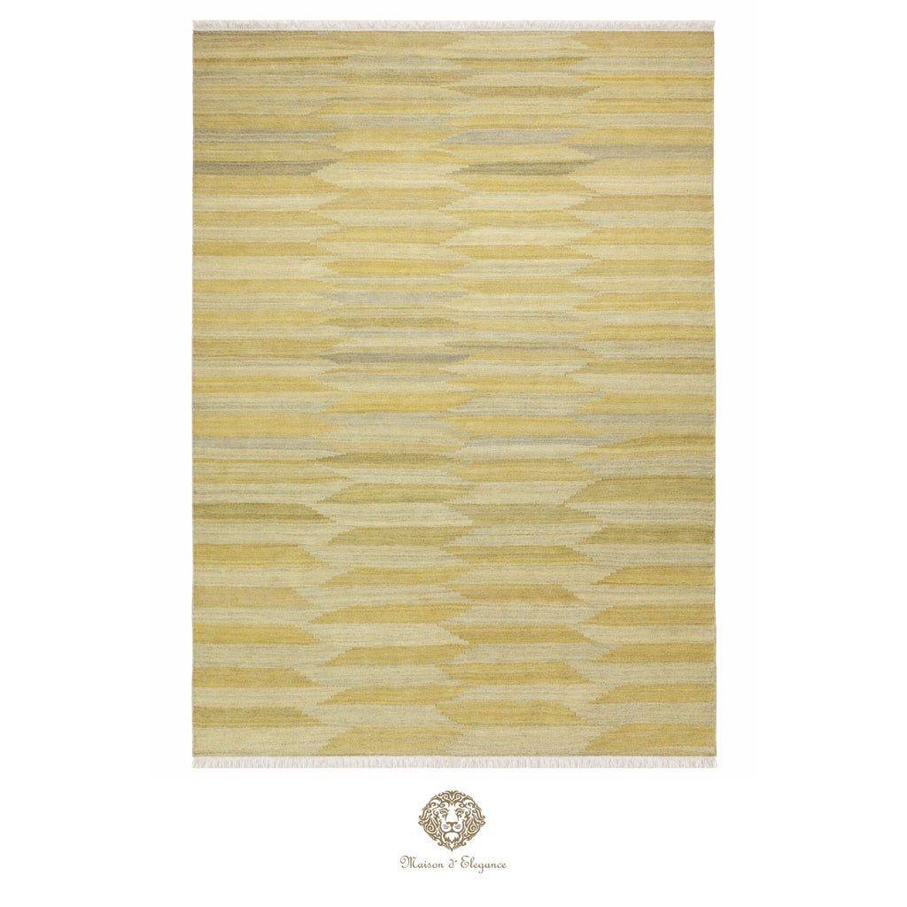 Yellow and beige patterned rug with a brand logo at the bottom center.