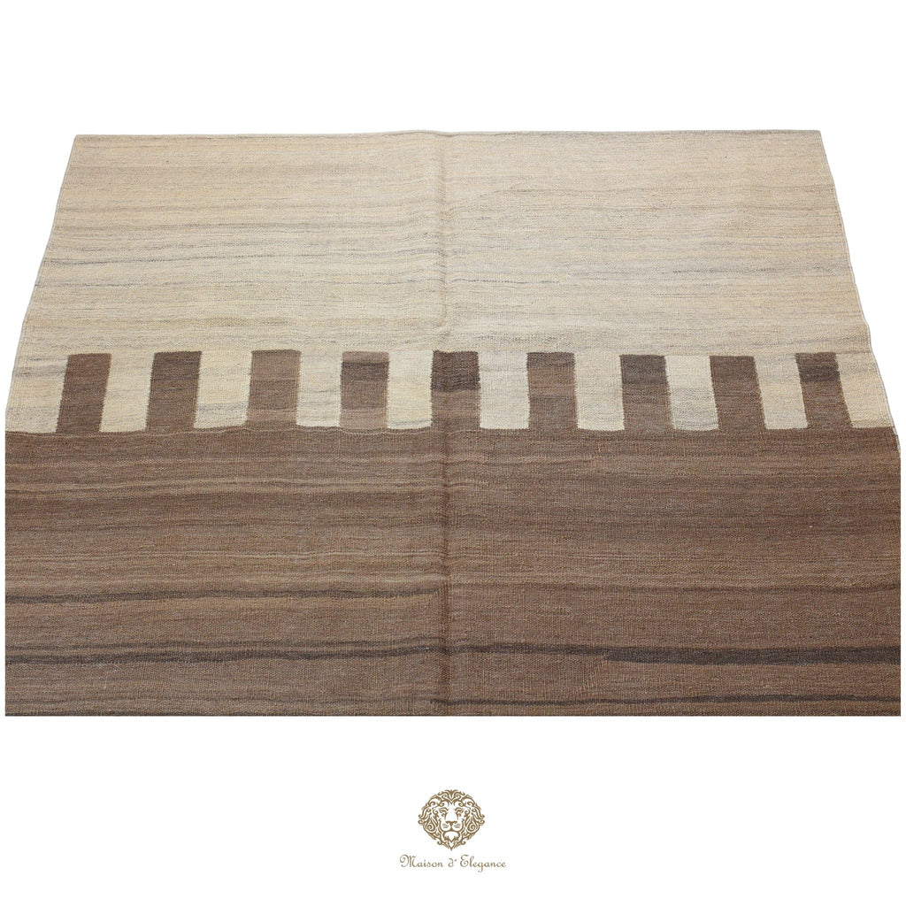 Folded woven fabric with brown and beige pattern on a white background