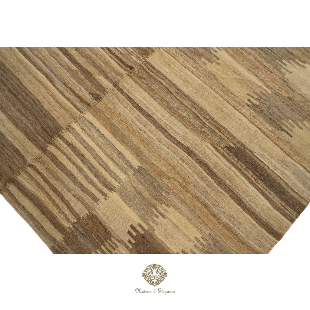 Close-up of a wooden floor with a patterned design, featuring a brand logo at the bottom.