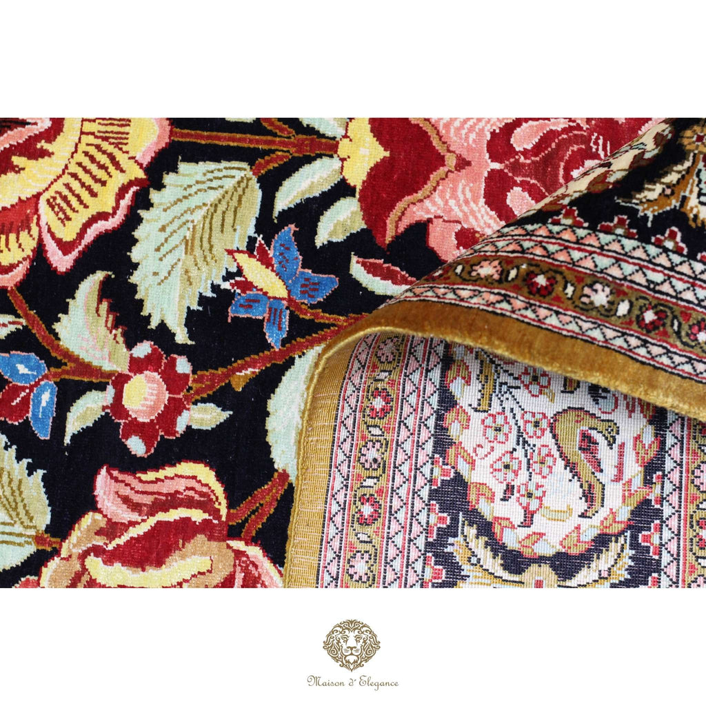 Close-up of a floral-patterned fabric with intricate designs on a black background.