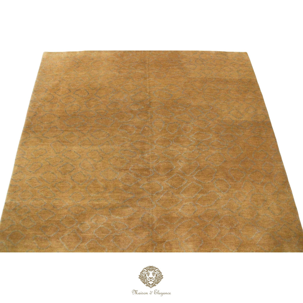 Gold-colored rug with subtle pattern on a brown background