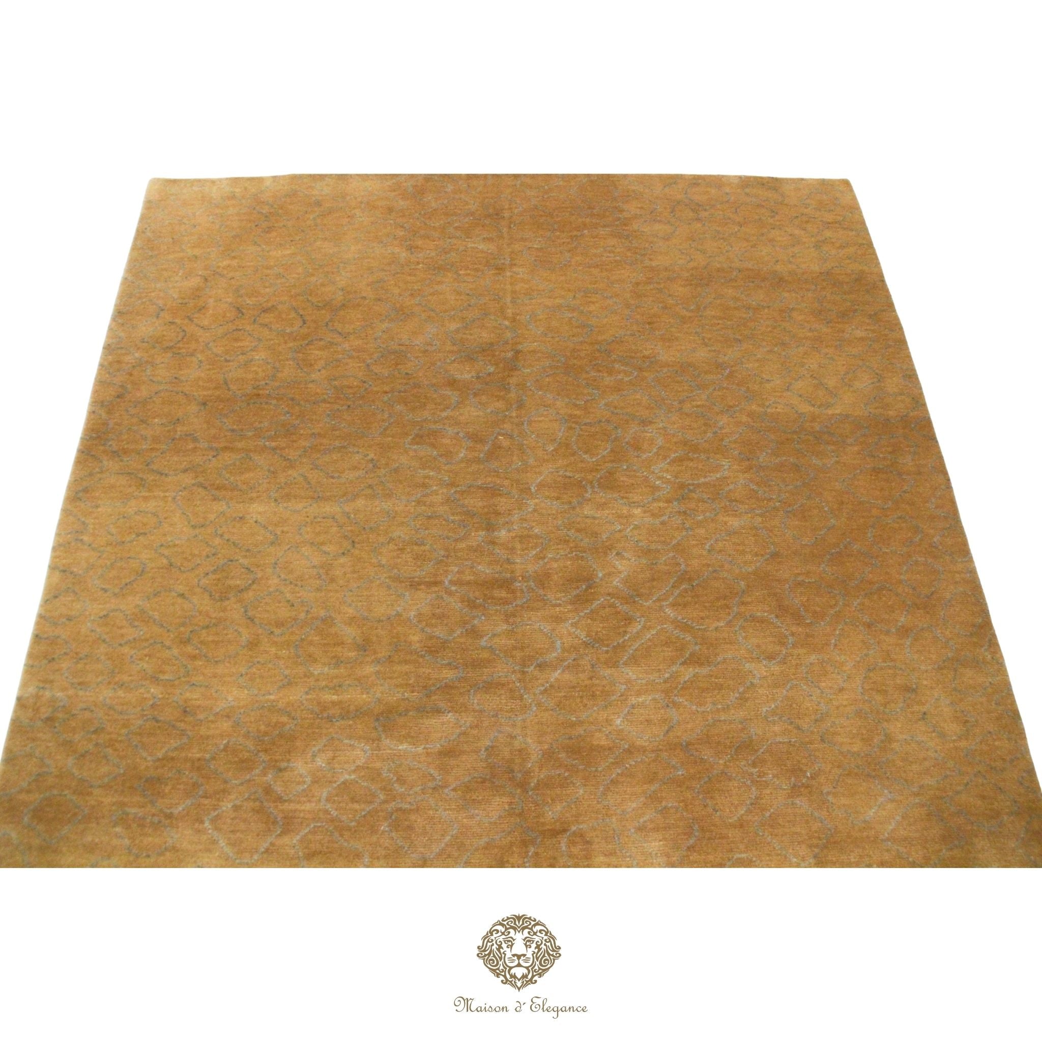 Gold-colored rug with subtle pattern on a brown background