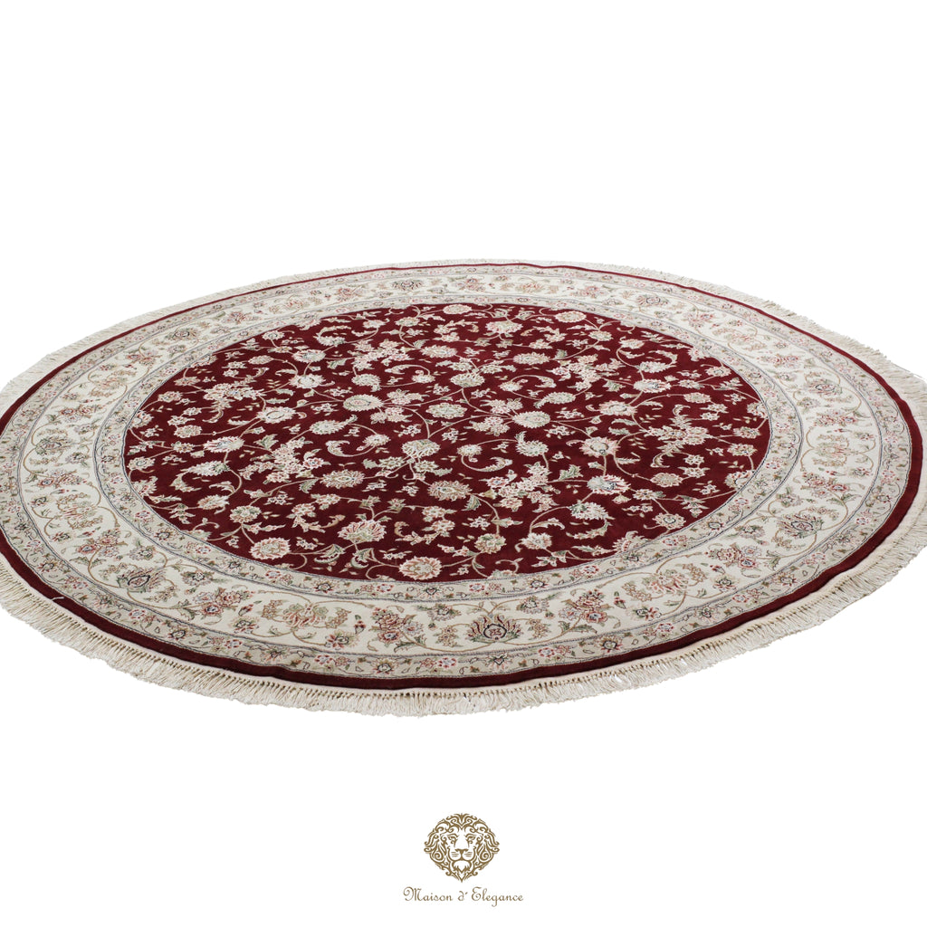 Round red and beige patterned rug on a red background