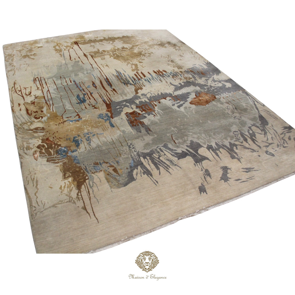 Abstract patterned rug with brown, beige, and gray colors on a Ivory background