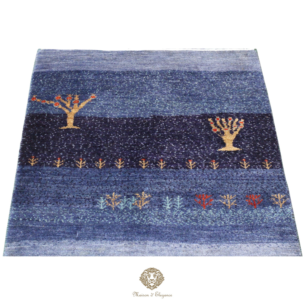 Blue textured rug with decorative patterns on a white background