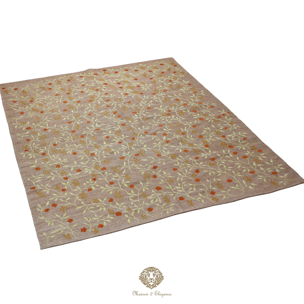Beige rug with floral pattern on a gray background
