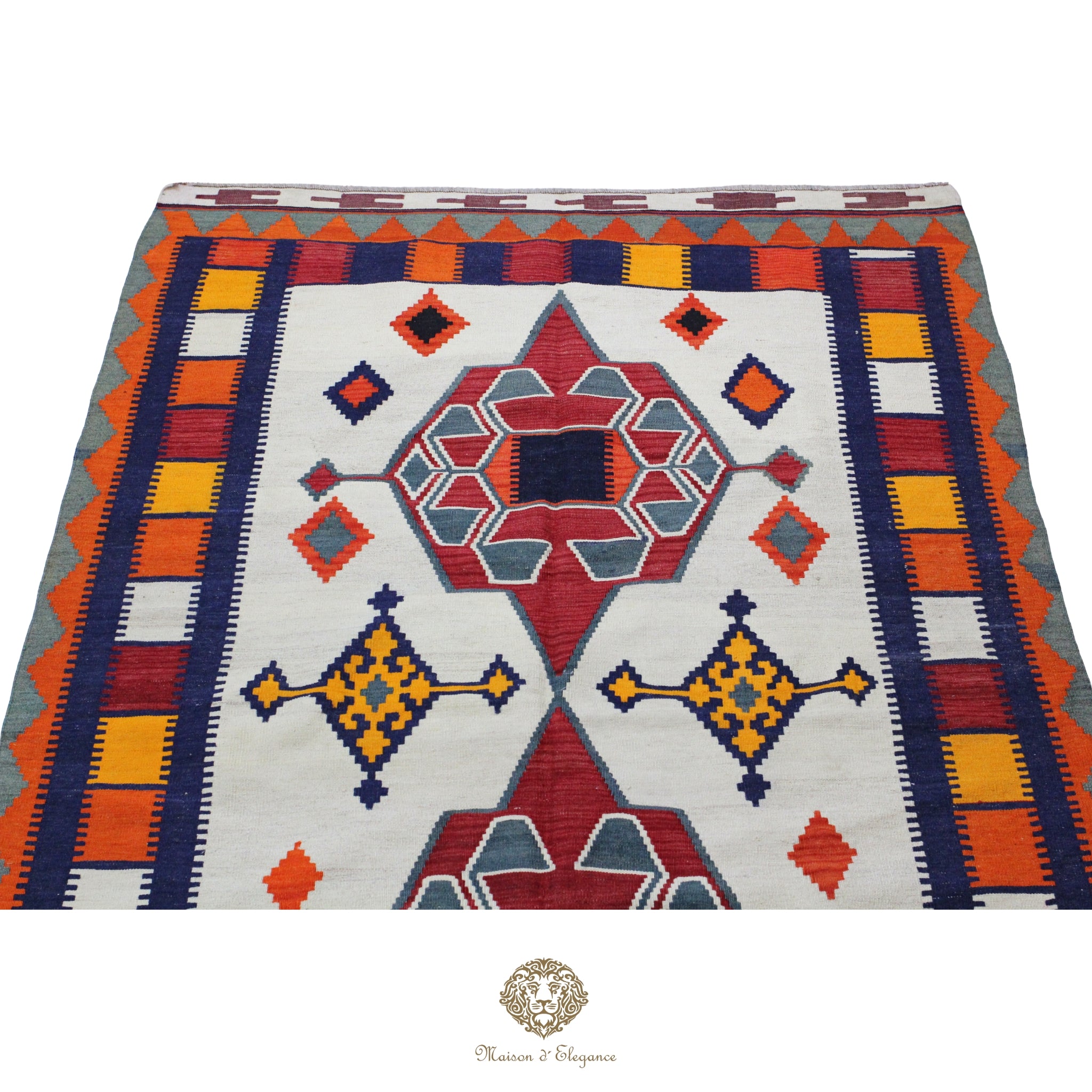 Colorful geometric patterned rug with a brand logo at the bottom.