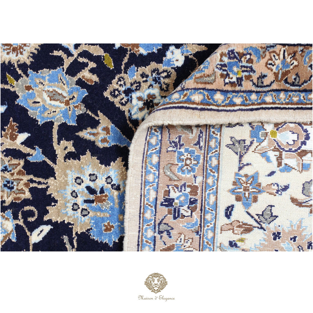 Close-up of a patterned rug with intricate designs in blue, beige, and brown.