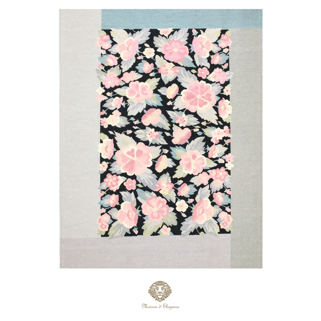 Floral patterned fabric with pink flowers on a black background, displayed on a light black background.