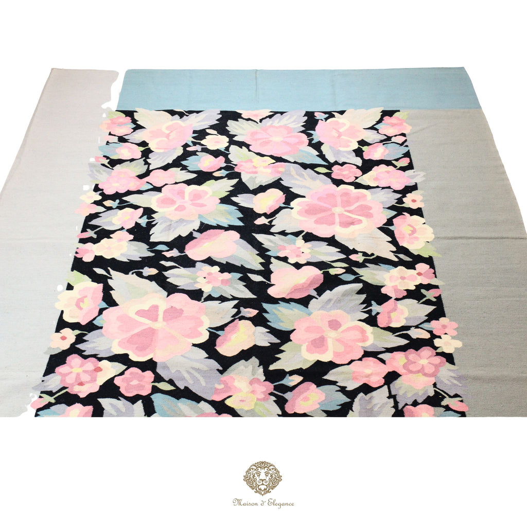 Floral patterned fabric on a flat surface with a visible brand logo.