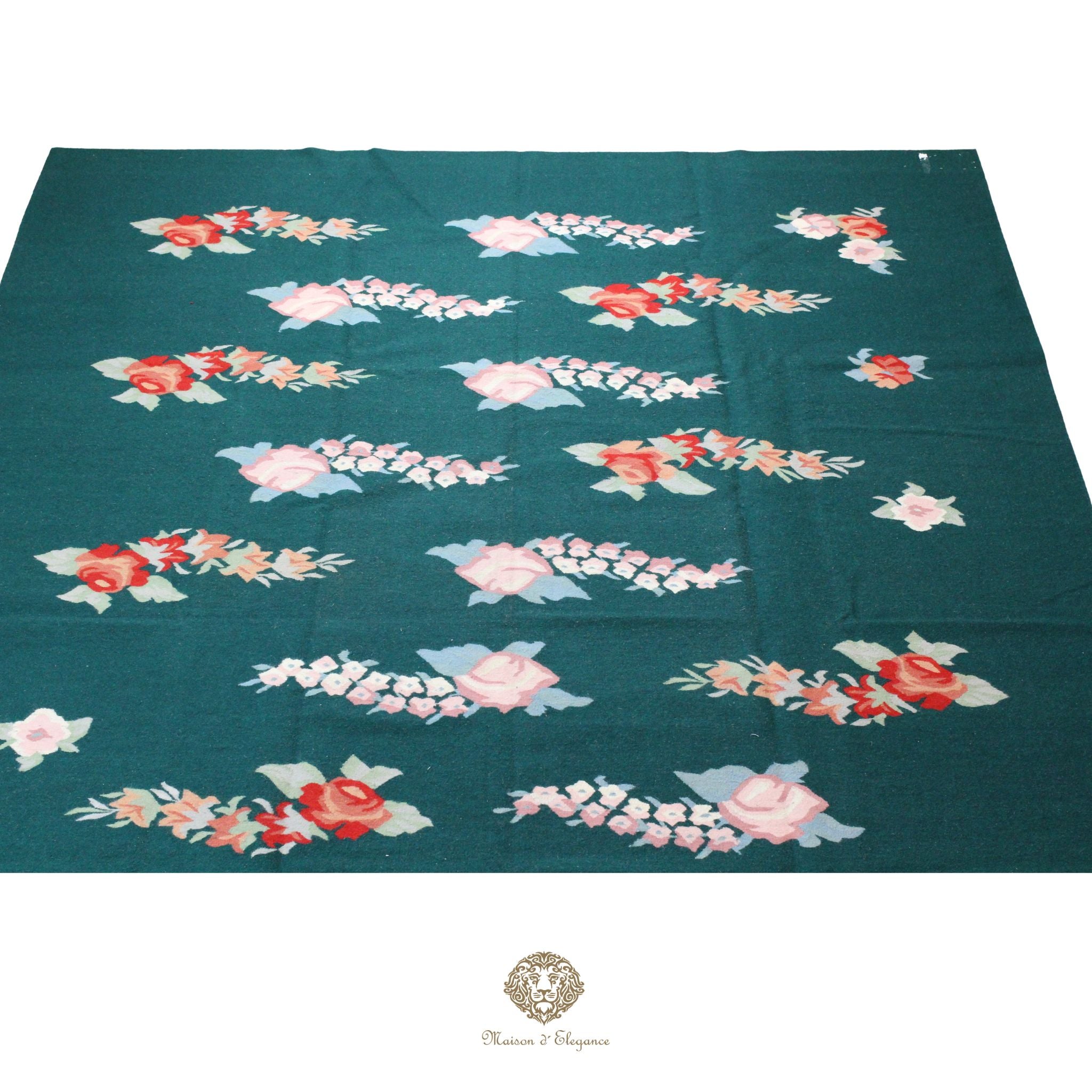 Floral patterned fabric on a teal background with a brand logo at the bottom.