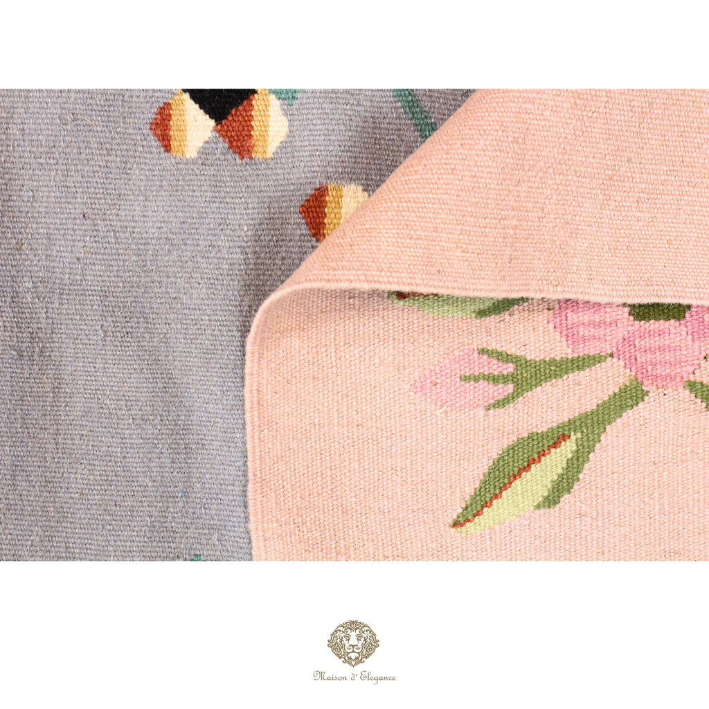Close-up of a floral-patterned fabric with a brand logo in the corner.